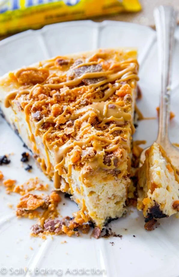 Butterfinger Peanut Butter Cheesecake topped with crushed Butterfinger candy