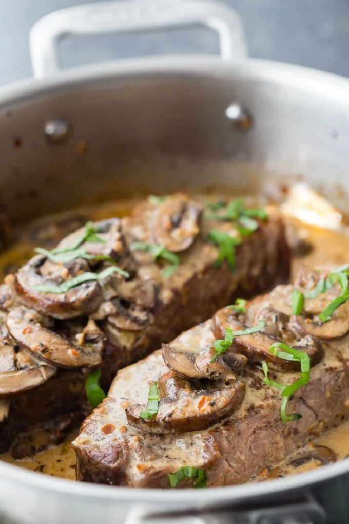 Creamy garlic mushroom Parmesan sauce served over steak