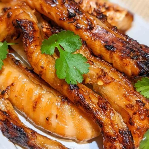 Crispy air-fried salmon belly served on a plate with garnish