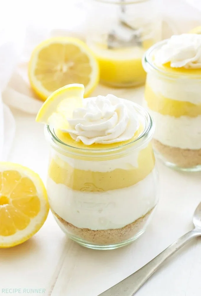 Delicious lemon curd vanilla cheesecake parfaits in serving glasses.
