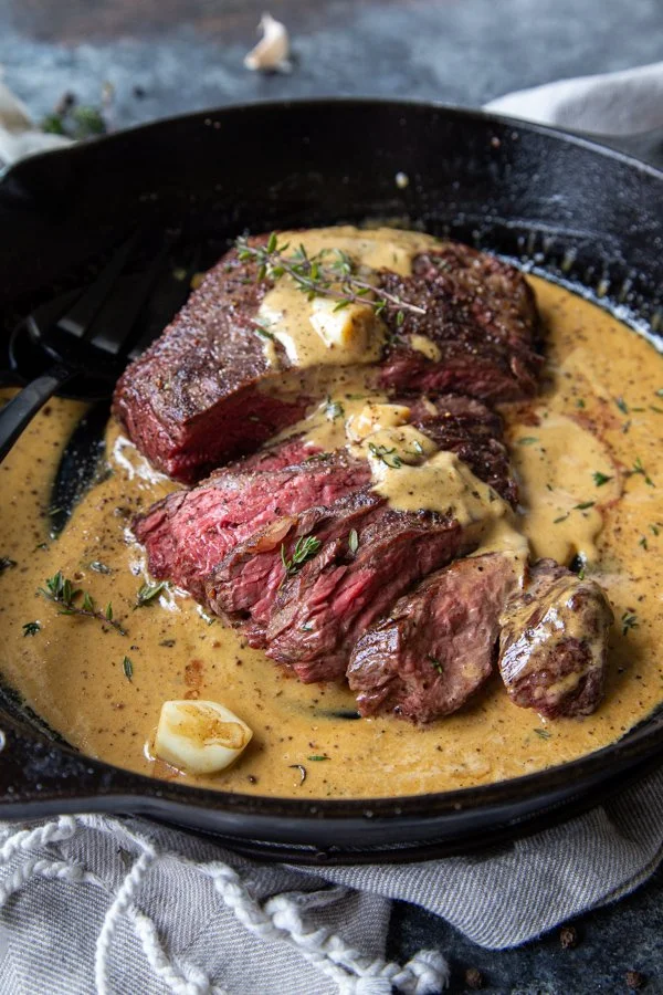 Whiskey Garlic Bavette Steak served with herbs and spices